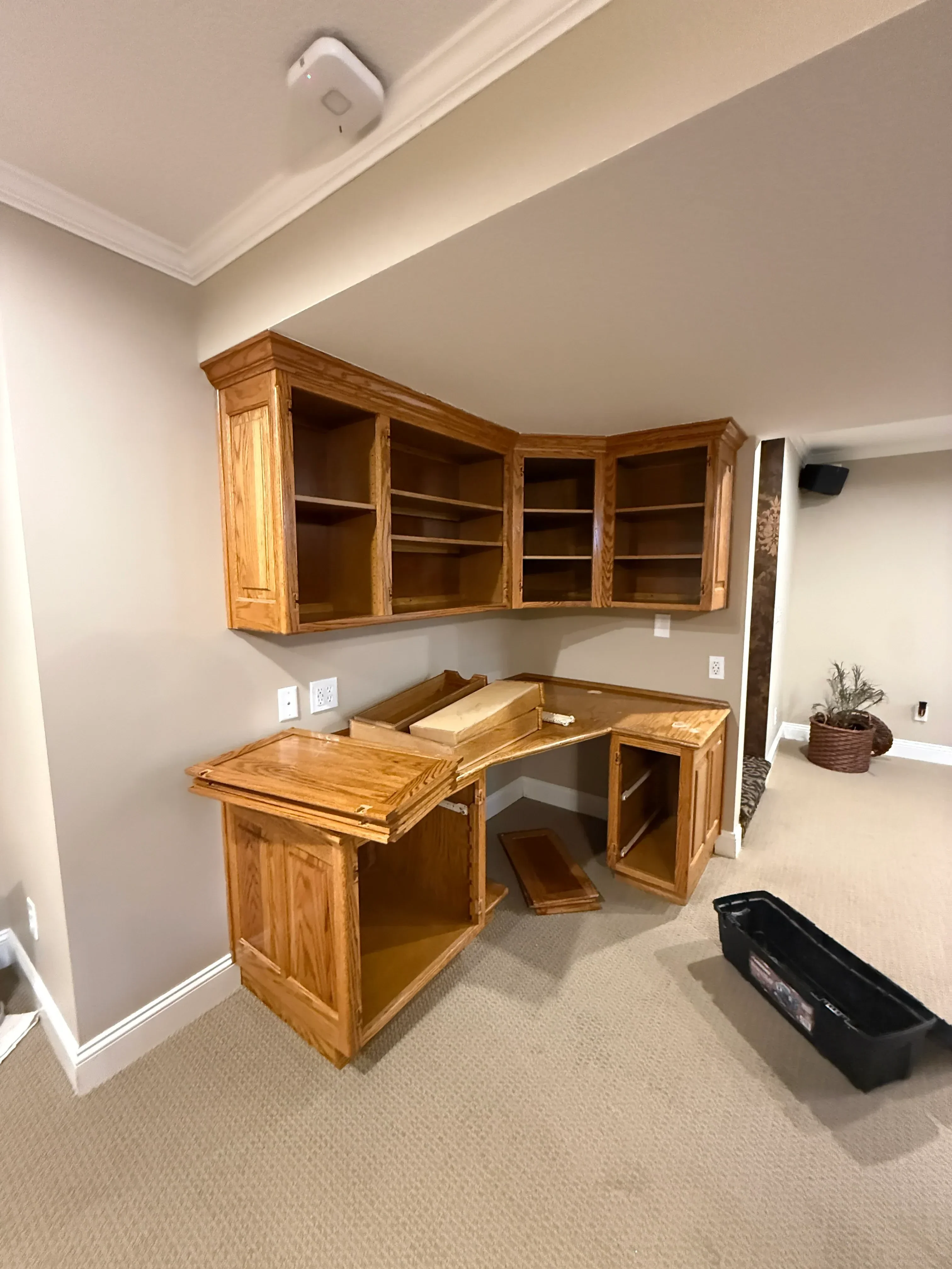 Refinished wooden cabinets with honey oak stain and open shelving compartments